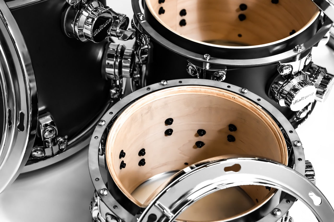 Close-up of a drum set with metallic and wooden components.