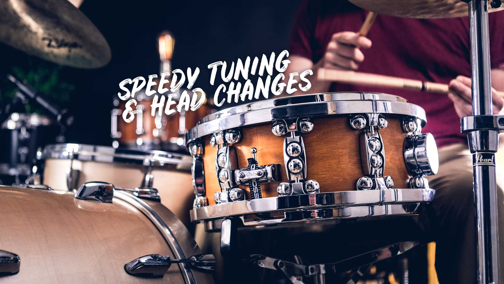 Dialtune snare drum being played with text Speedy Tuning & Head Changes overlaid