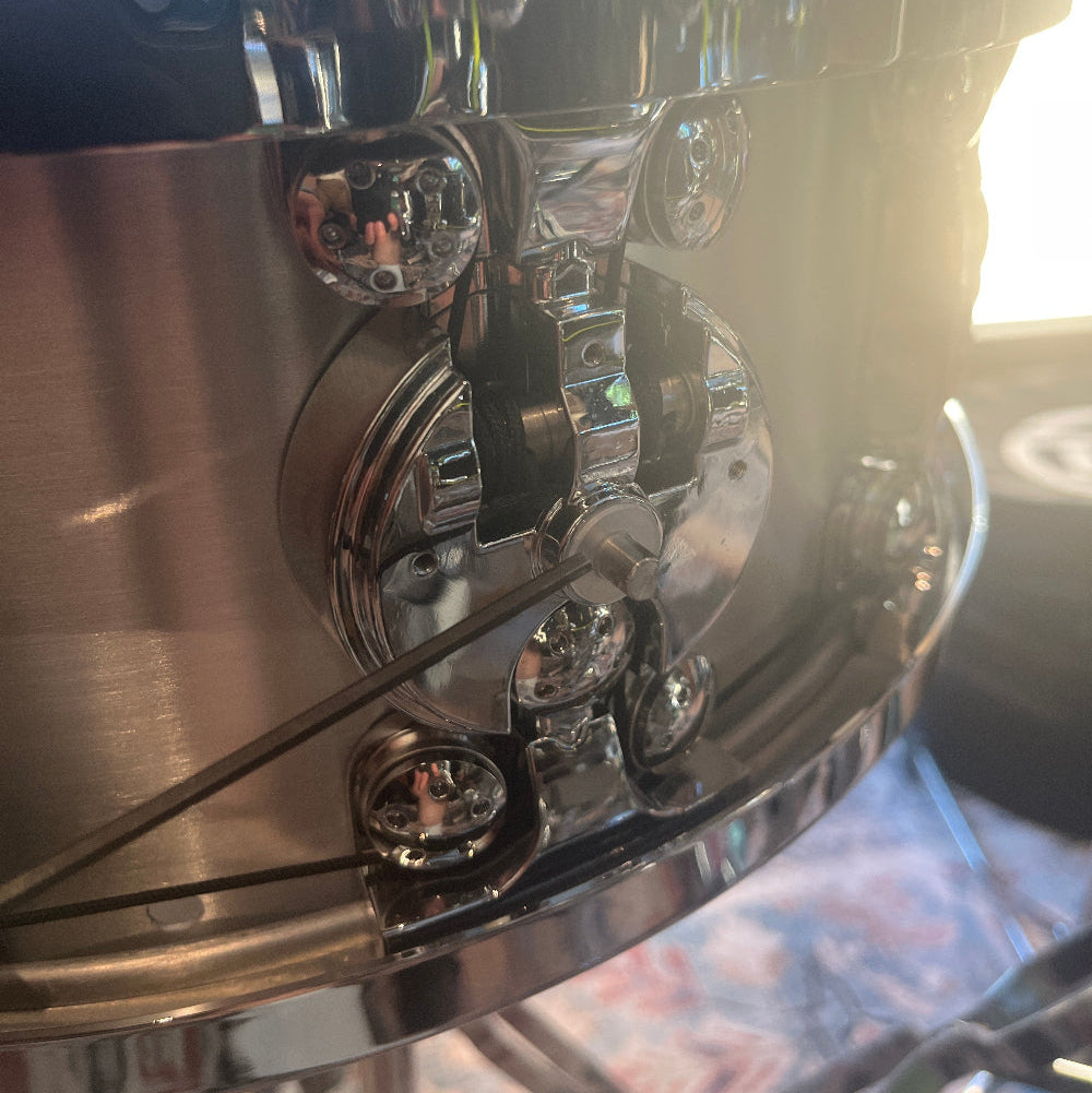 Close-up of a Dialtune snare with the dial cover removed showing the factory second washer installed.